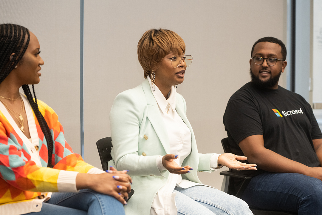 students, faculty and staff chat at an event during Diversity Week