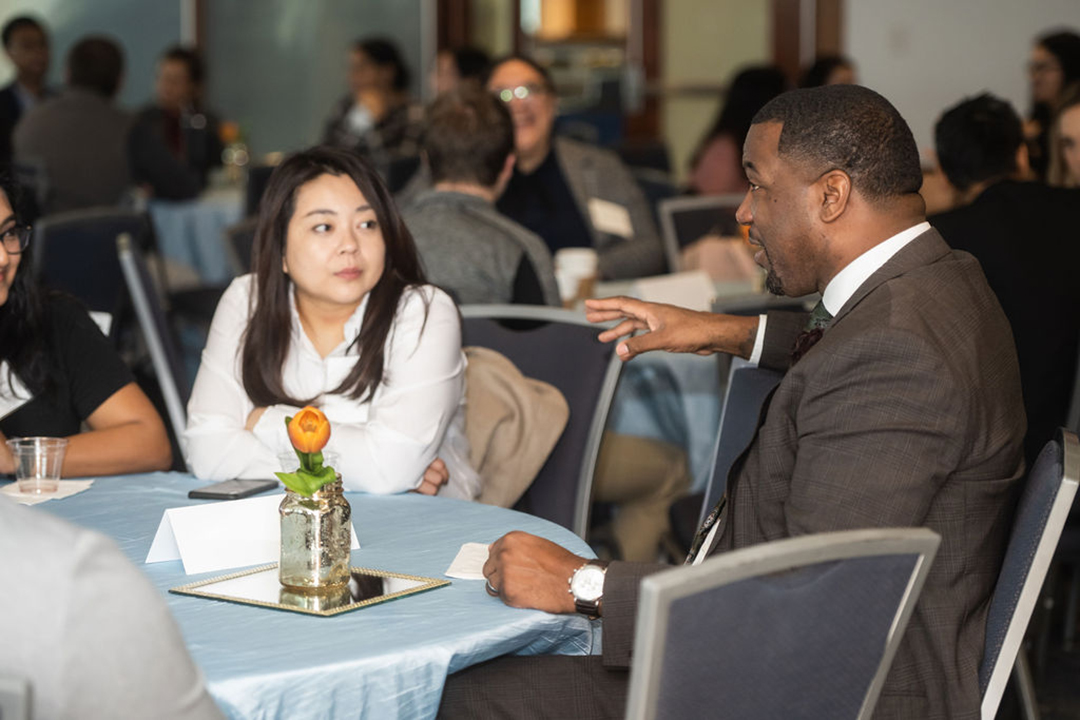 students chat with distinguished guests at a GWSB Industry Roundtable event