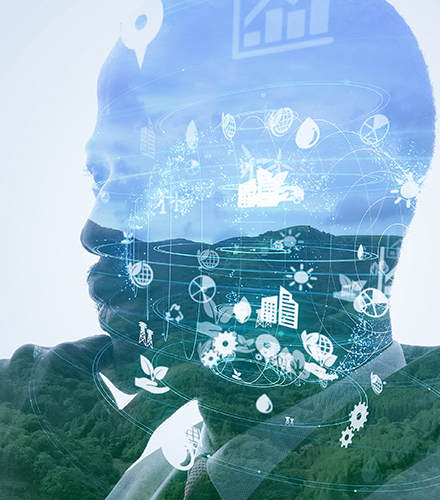 composite image of a businessman reflecting on environmental issues; the photo of the man is blended with an image of a forest