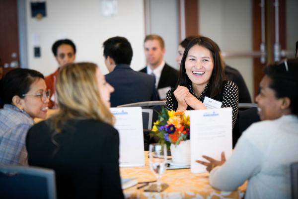 groups of smiling people seated around tables during a GWSB event