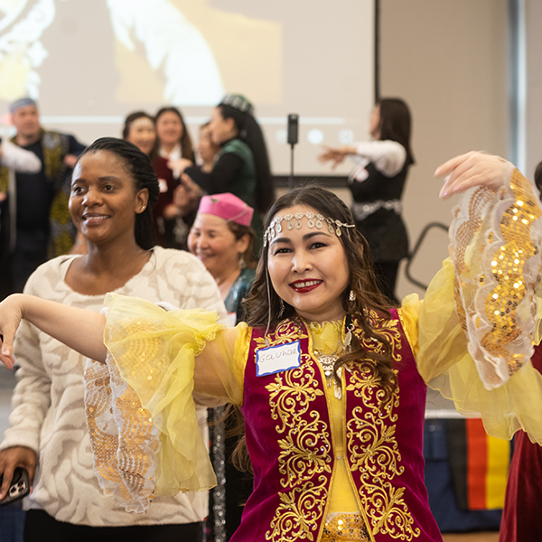 person dancing and smiling at camera at diversity allyship week event
