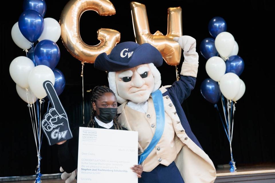 George Mascot poses with a scholarship recipient